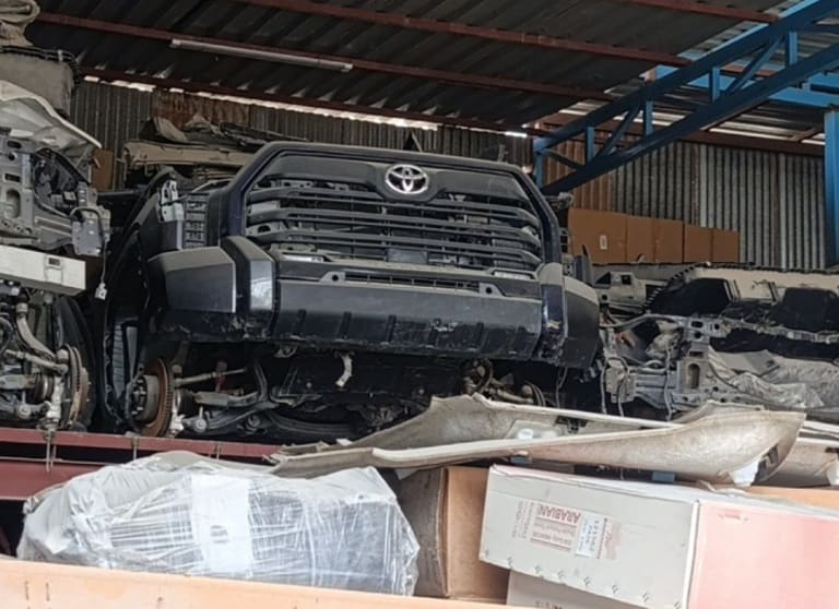 Dark grey Toyota Tundra pickup front halfcut — grille, bumper and radiator support, Sharjah market