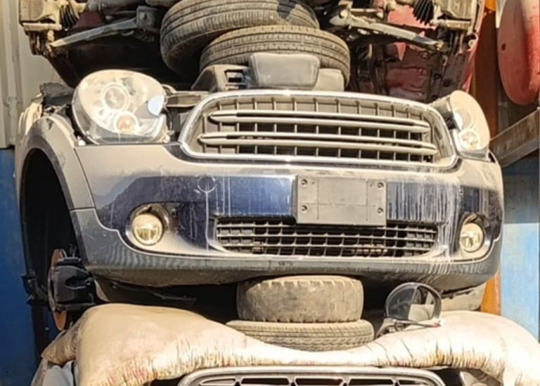 Dark blue MINI Cooper hatchback front cut — bumper, grille, headlights and fog lights, Sharjah market