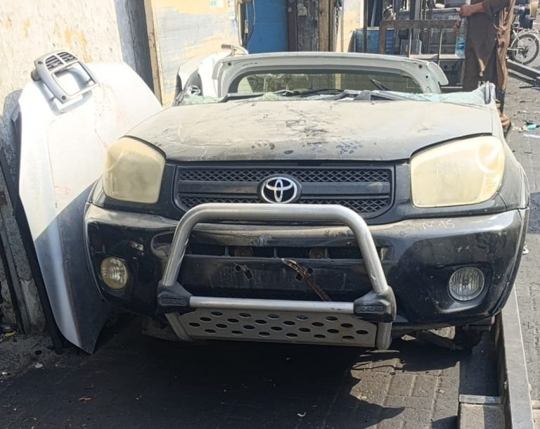 Black Toyota RAV4 SUV front halfcut — bumper, grille, headlights and bull bar, Sharjah market