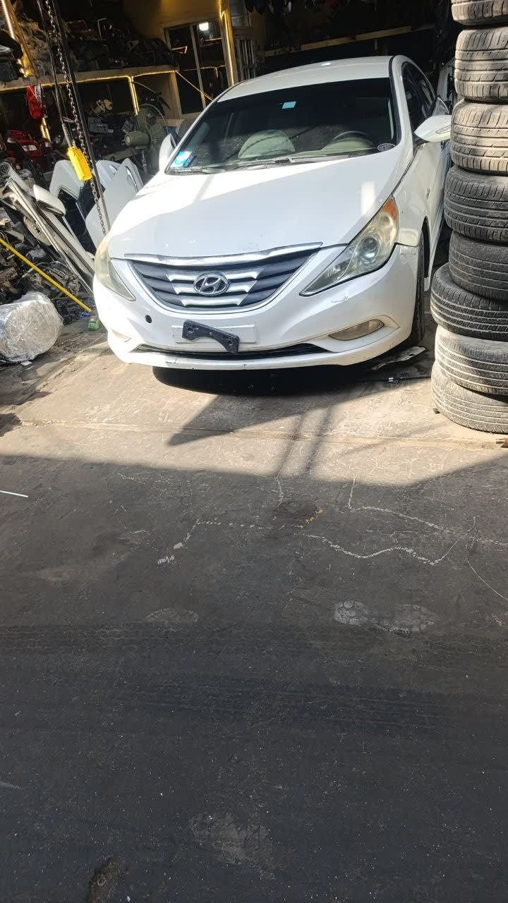 White Hyundai Sonata sedan front for parts — bumper, grille, hood and headlights, Sharjah market