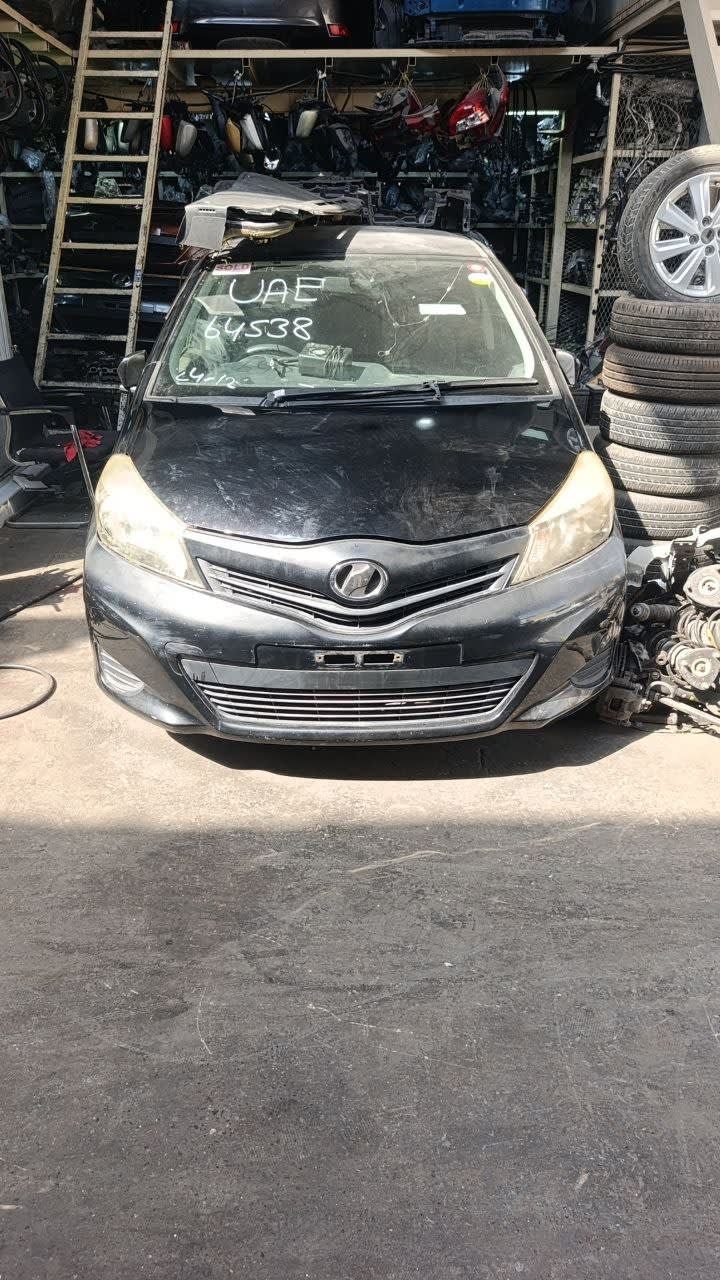 Black Toyota Yaris hatchback front halfcut — bumper, grille and headlights, Sharjah market