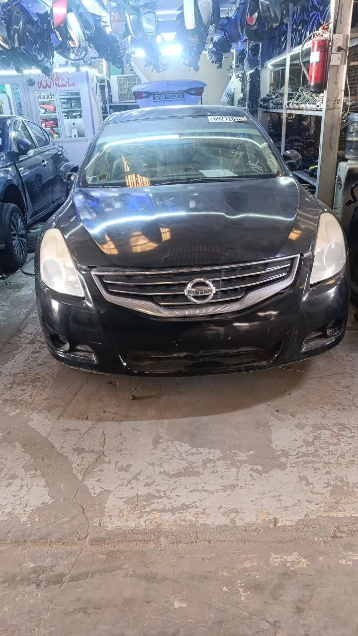 Black Nissan Altima sedan halfcut front — bumper, grille and headlights, Sharjah market