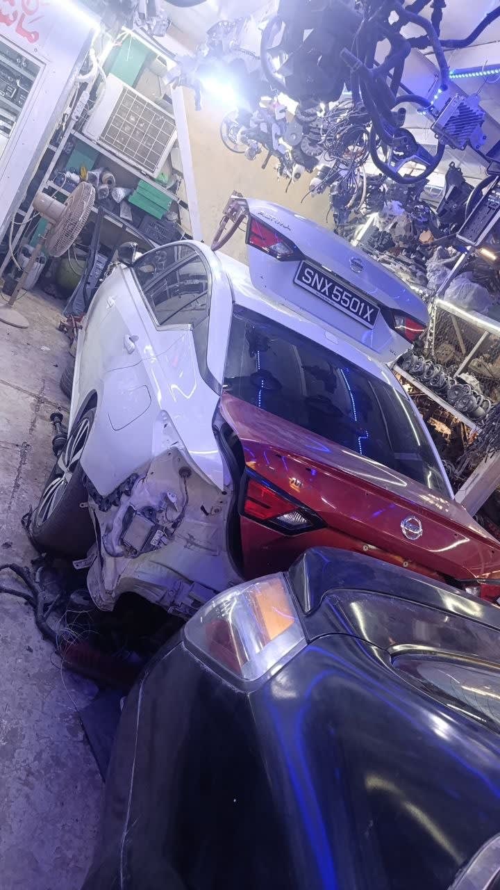 White Nissan Altima sedan halfcut rear — trunk lid, tail lights and quarter panels, Sharjah market