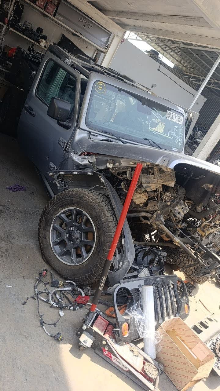 Grey Jeep Wrangler SUV halfcut — door, grille, alloy wheel and engine bay, Sharjah market