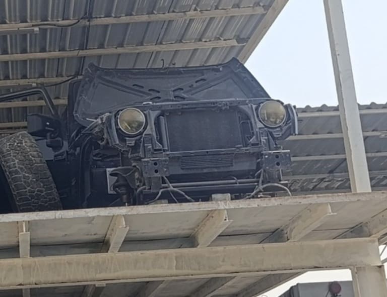 Black Hummer H1 SUV front halfcut — hood, dual headlights, grille and radiator support, Sharjah market
