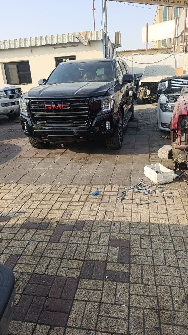 Black GMC Yukon SUV car for parts — front bumper, GMC grille and headlights, Sharjah market