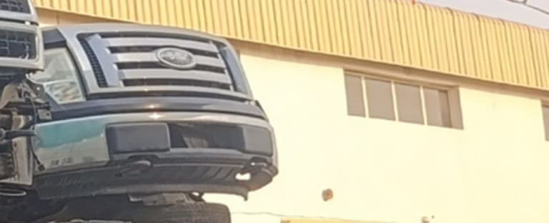 Dark grey Ford F150 pickup halfcut — chrome grille, front bumper and headlights, Sharjah market