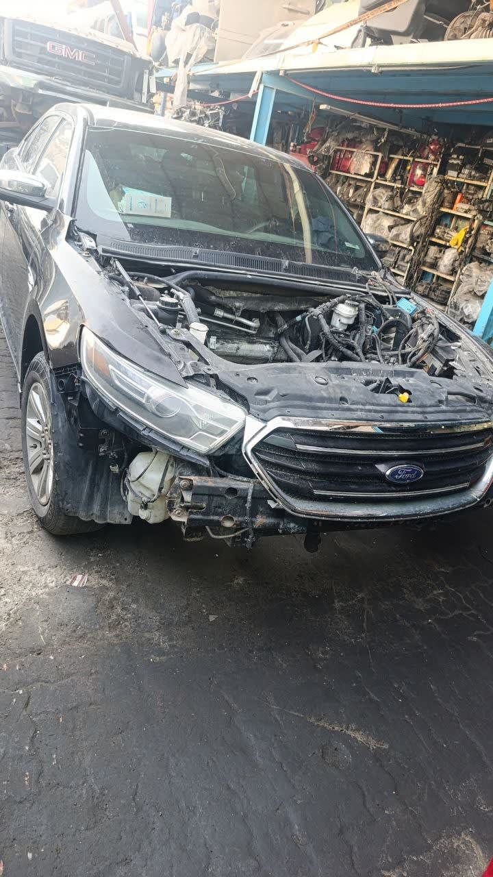 Black Ford Taurus sedan halfcut front — headlight, grille, hood and engine bay, Sharjah market