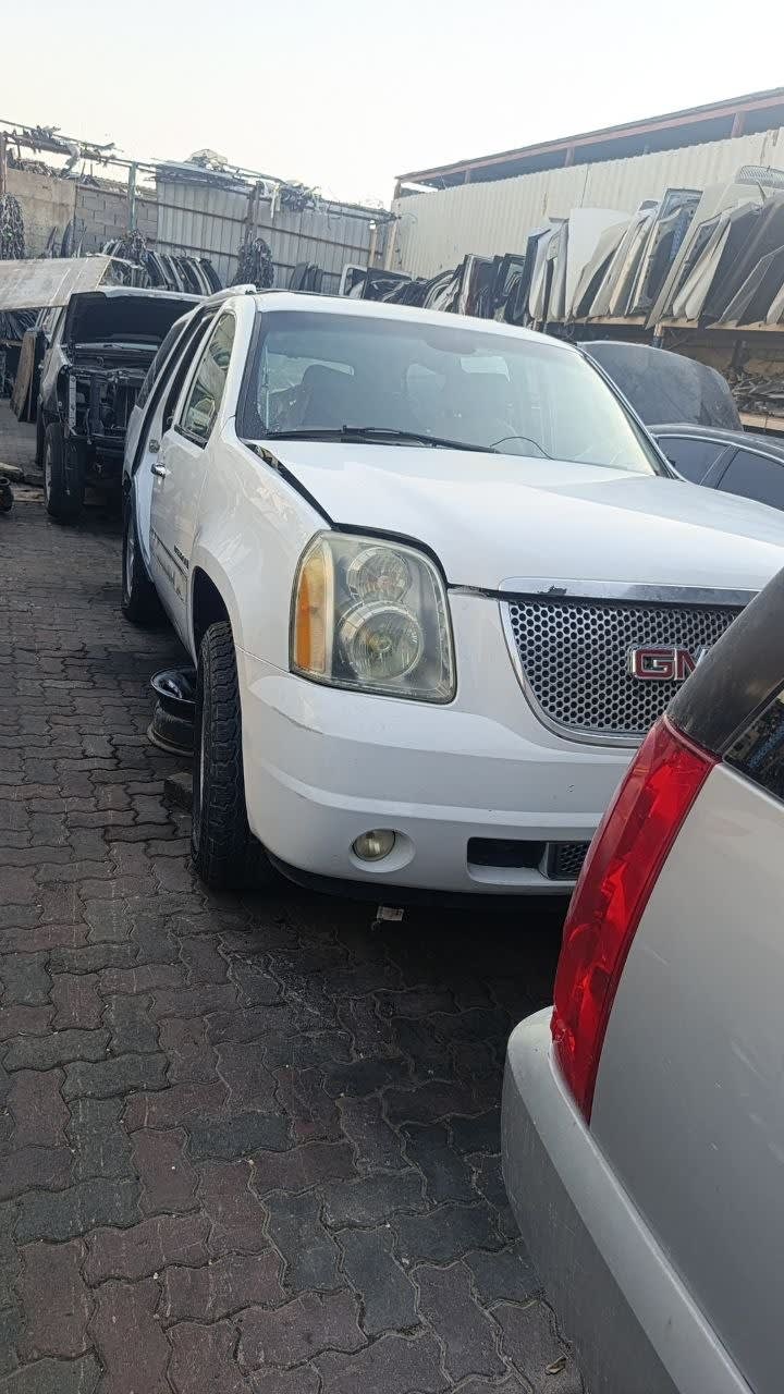 White GMC Yukon Denali SUV front — bumper, grille, headlight and fender, Sharjah market