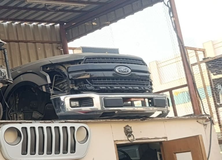 Dark grey Ford F150 pickup front cut — grille, chrome bumper and fog lamps, Sharjah market