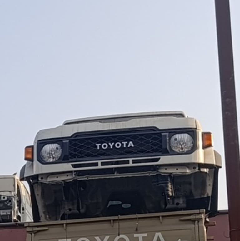 Beige Toyota Land Cruiser 70 Series halfcut — grille, round headlights and front panel, Sharjah market
