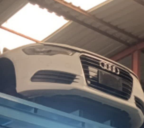 White Audi A6 front cut — bumper, single-frame grille and headlights, Sharjah market