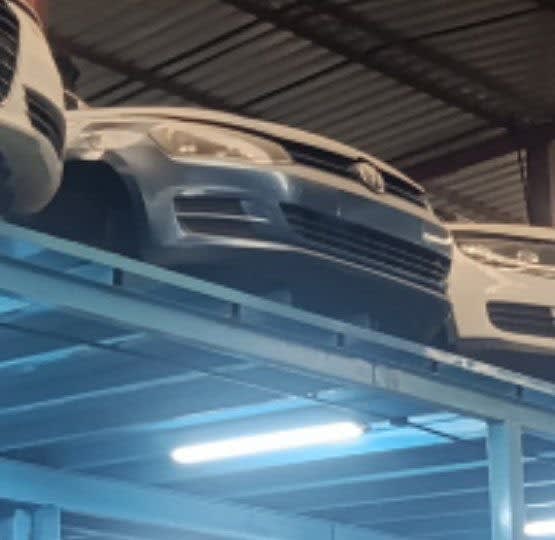 Silver-grey Volkswagen Touareg front halfcut — bumper, grille and headlights on rack, Sharjah market