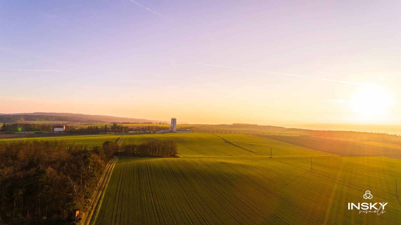 Aerial image of the countryside featuring the insky logo