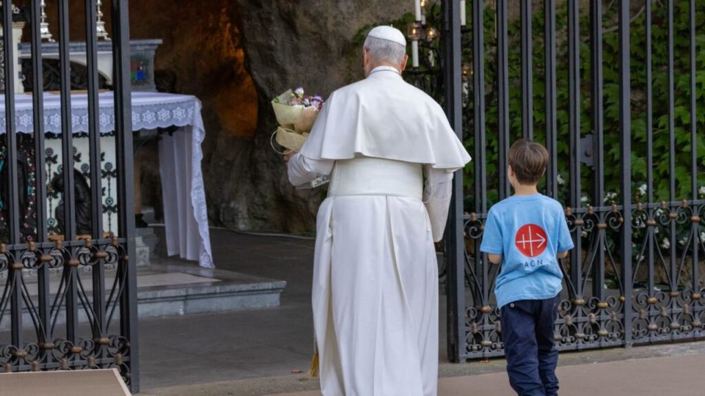 Pope Leo XIV brings flowers to Mary at a replica of the grotto of the Sanctuary of Our Lady of Lourdes during a rosary prayed with children in the Vatican Gardens on Oct. 1, 2026. | Credit: Daniel Ibáñez/EWTN News/Vatican Pool