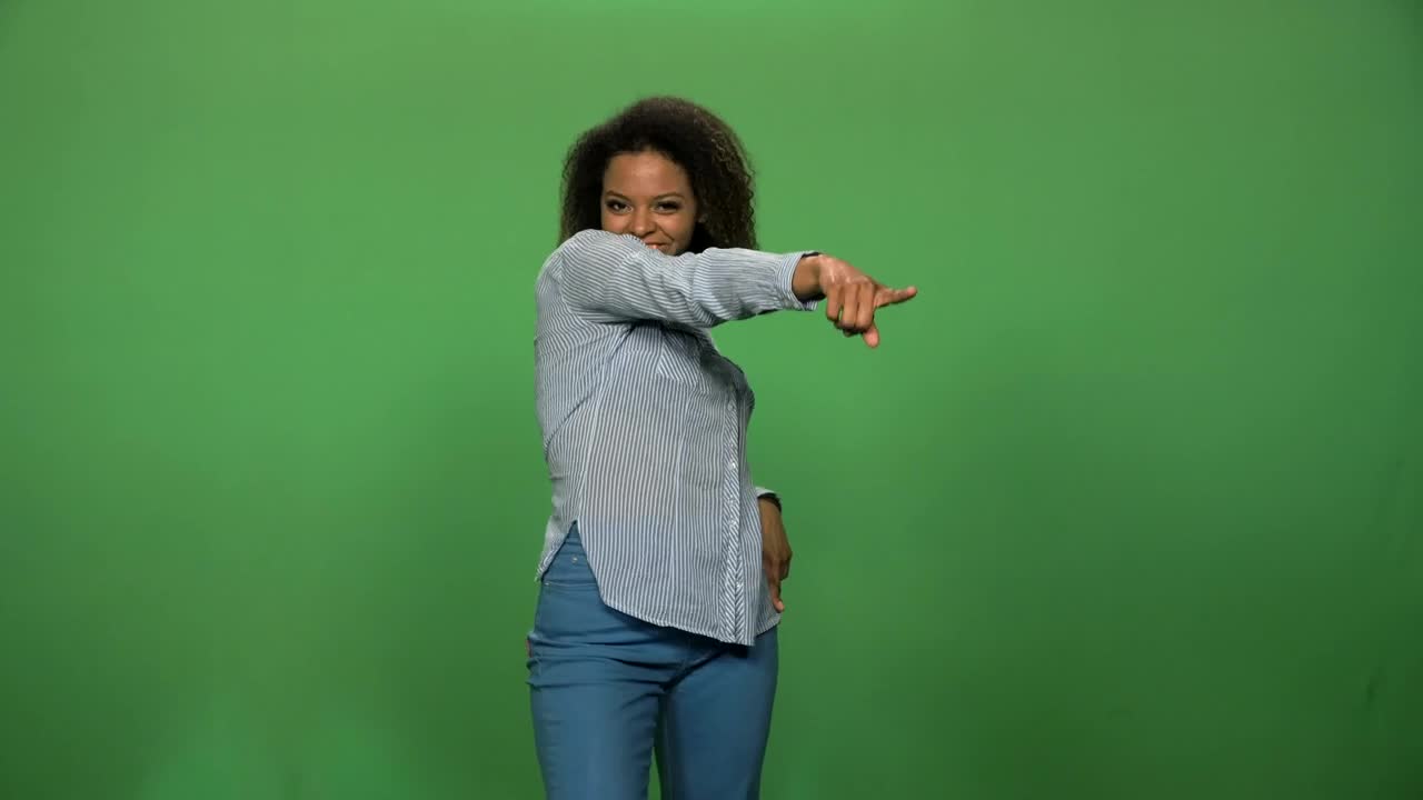 A Woman Dancing in Front of a Green Screen preview