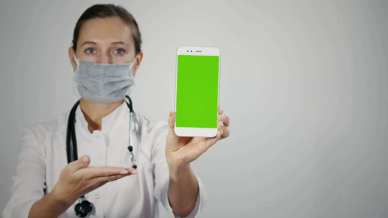 Female Doctor Displaying Mobile with Green Screen preview