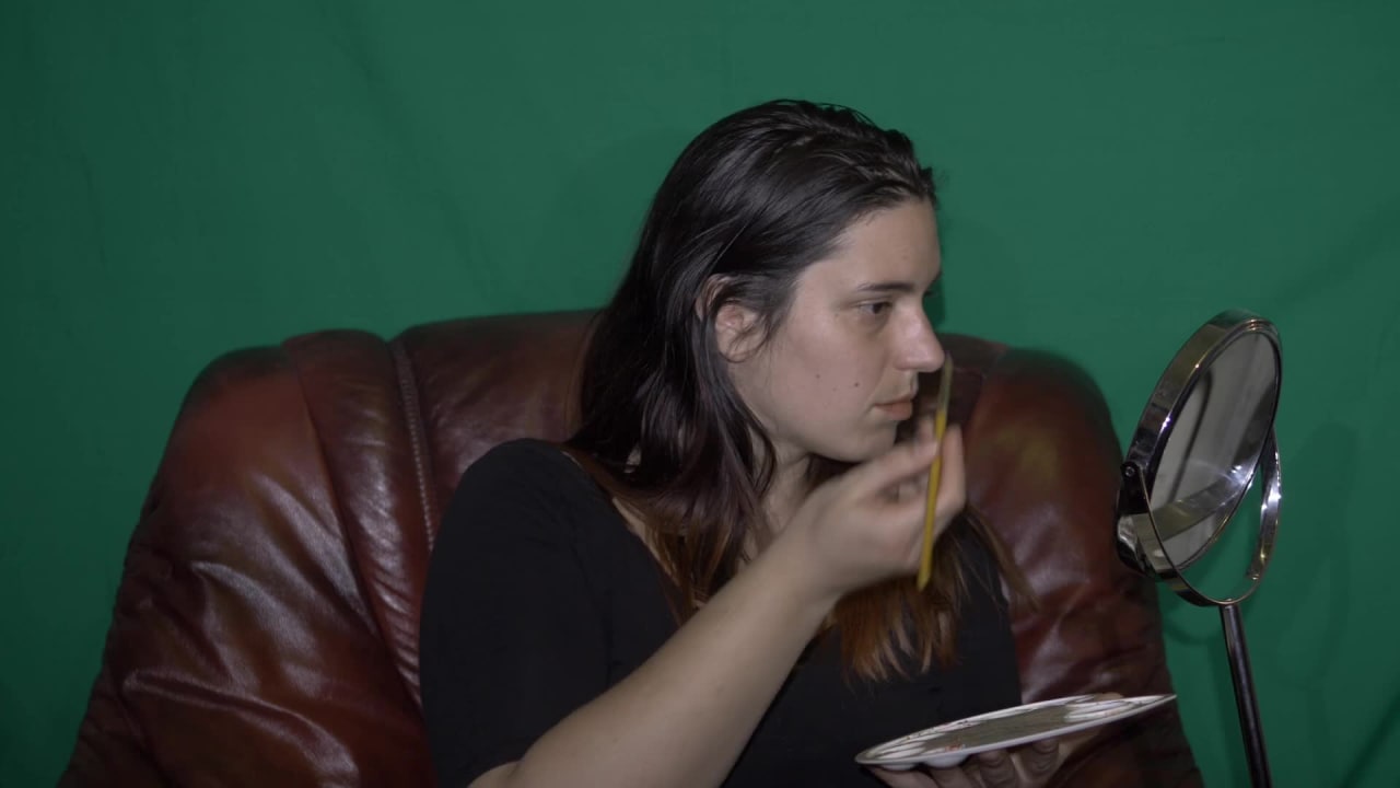 Girl Apllying Makeup with a Green Background preview
