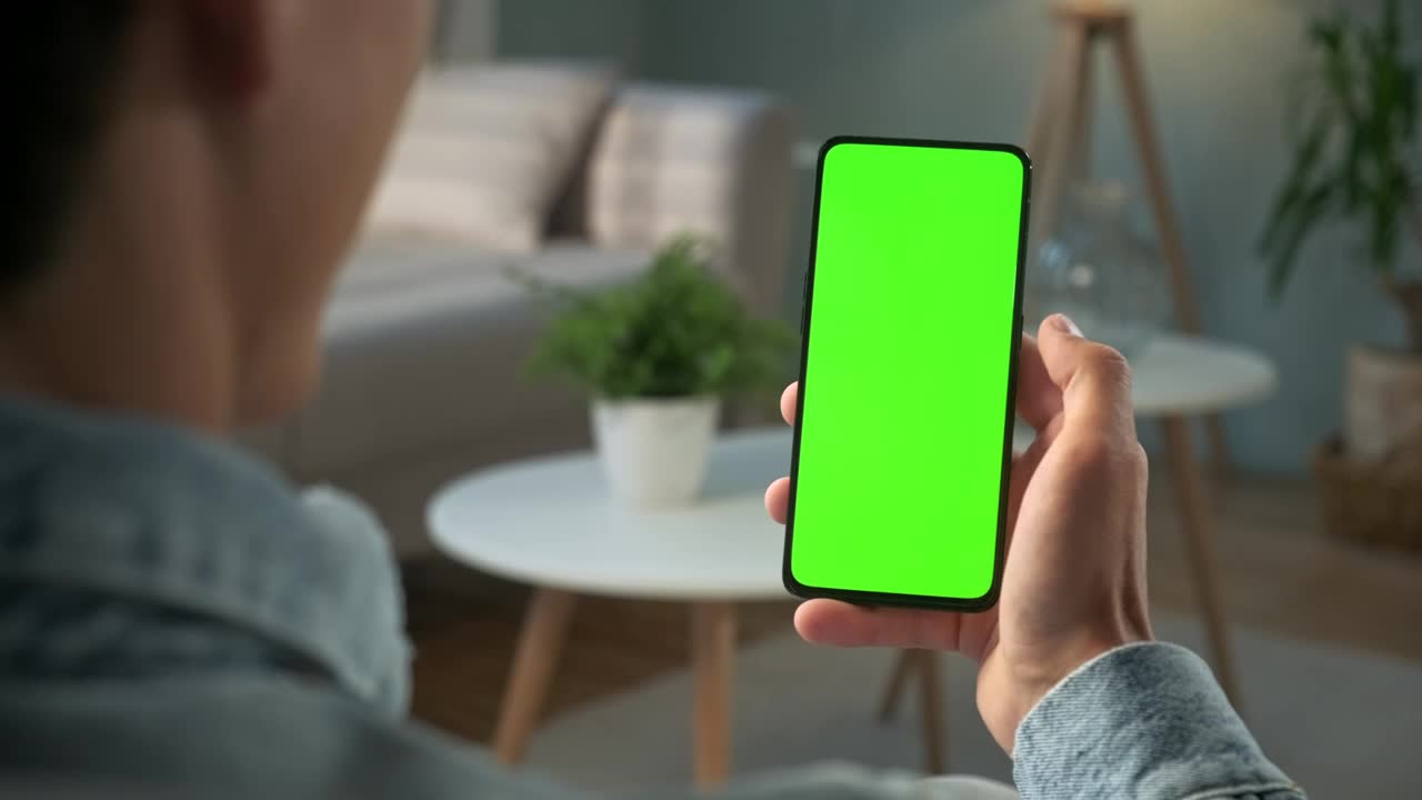 Man Watching to a Green Screen Smartphone preview