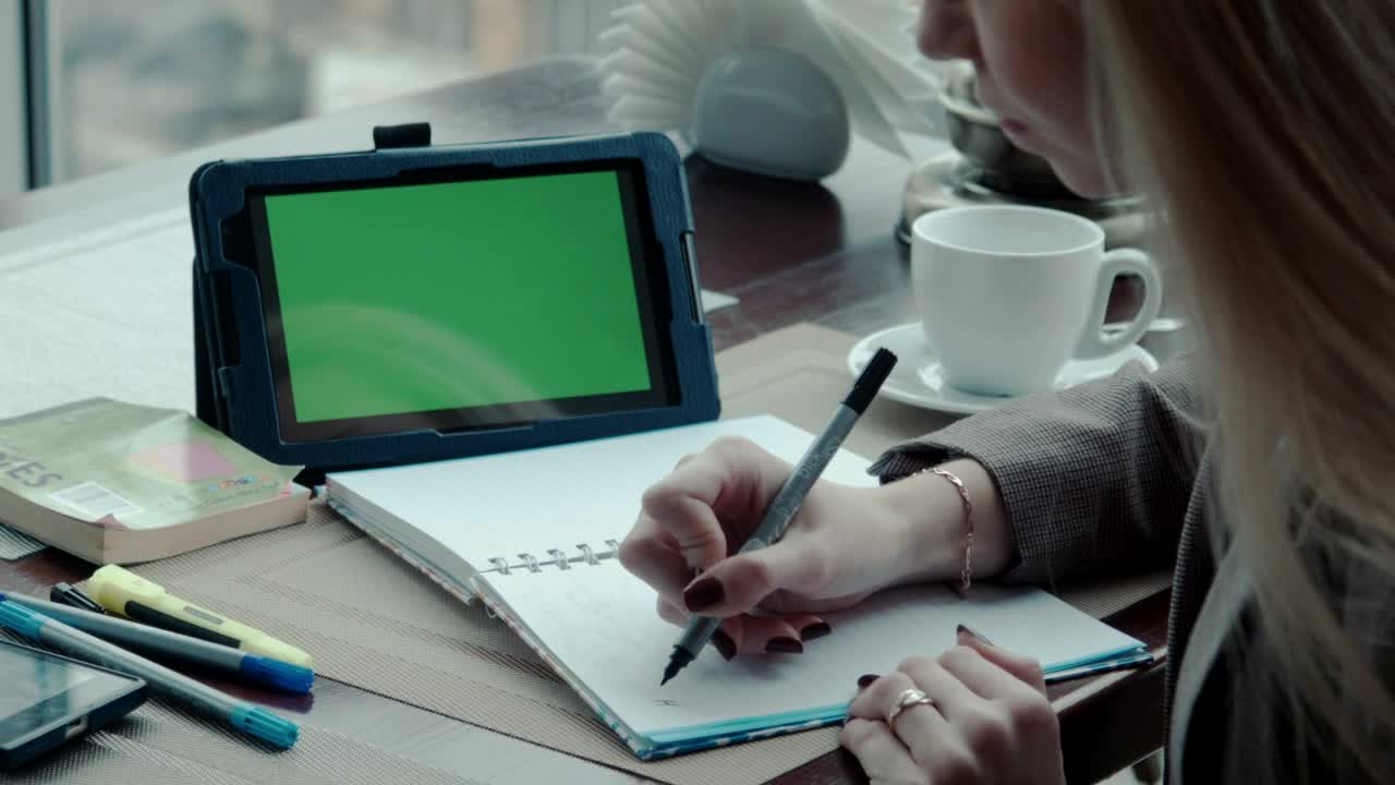 Writing a Note on a Note Book Using Tablet Free Green Screen preview