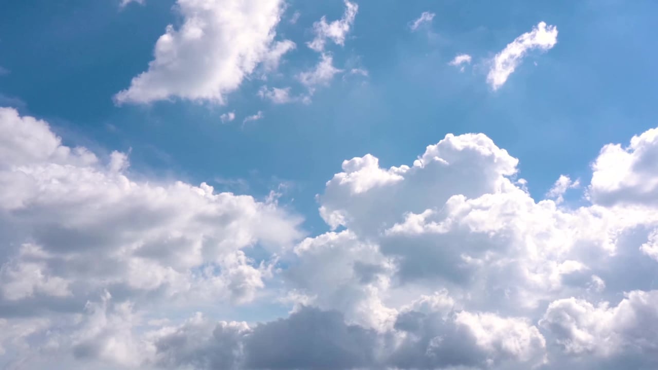 White Clouds Moving Across a Clear Blue Sky Quickly preview