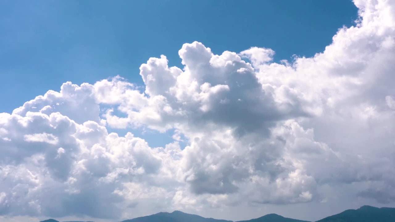White Clouds Moving Across a Clear Blue Sky preview