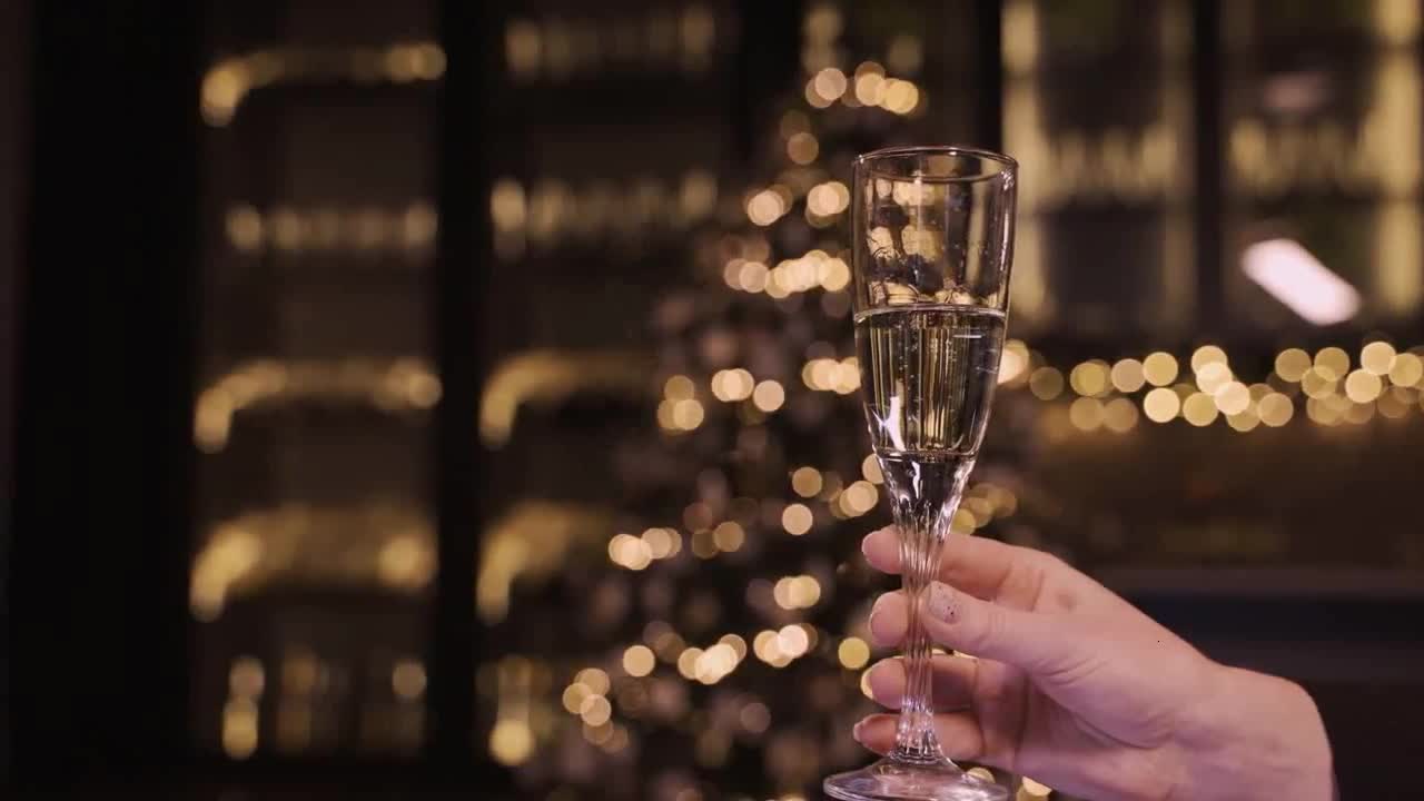 Camera focus on champagne glass in party preview