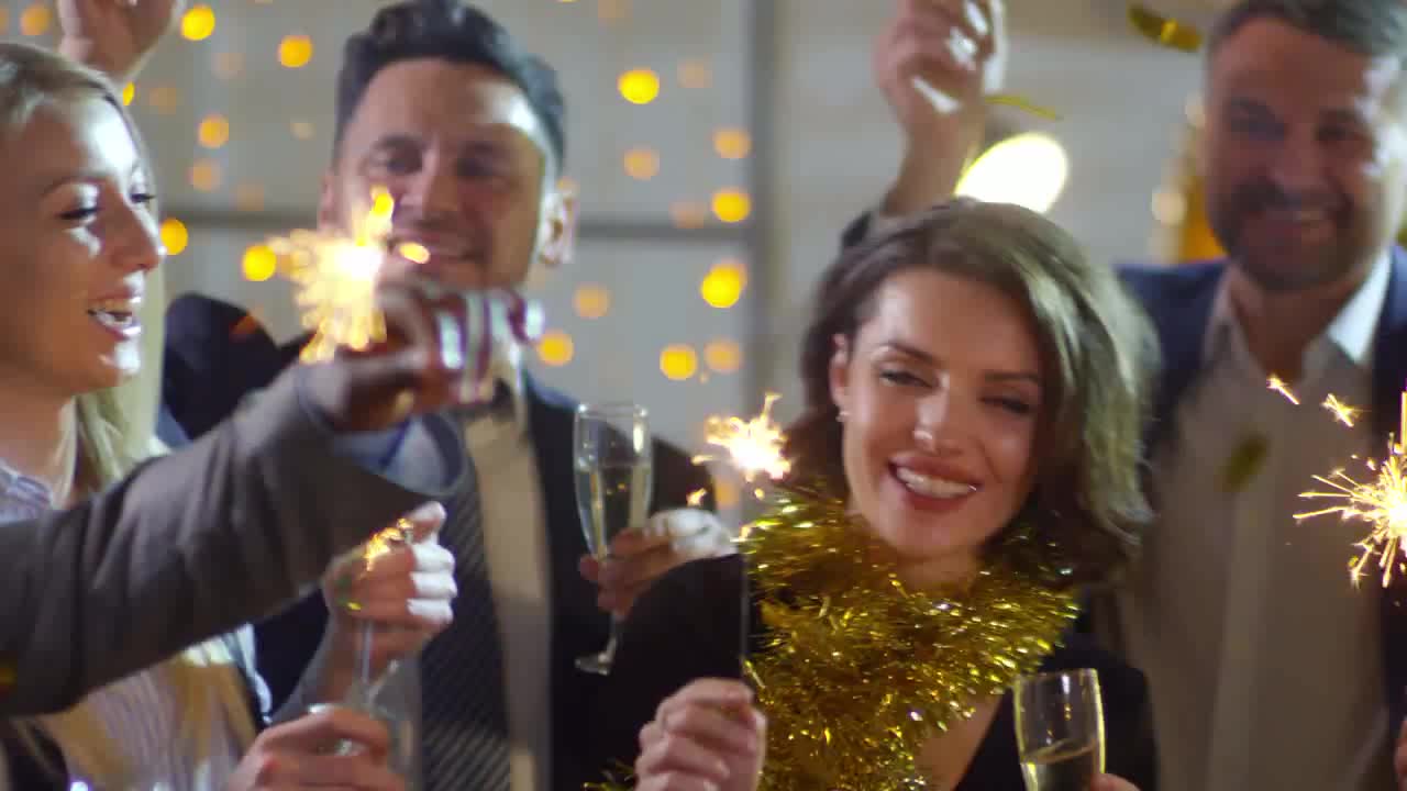 Camera focus on dancing girls playing sparklers and confetti preview