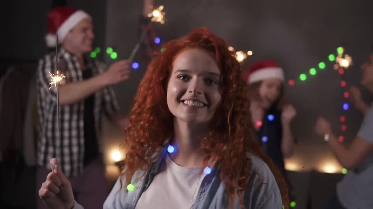 Camera focus on girl that dance with sparkler preview
