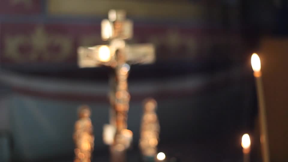 Camera slowly focus on cross and candles preview