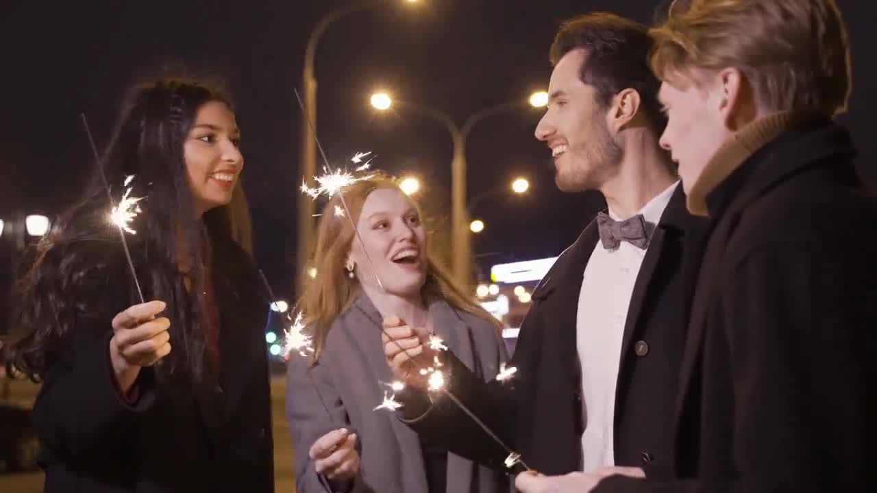 Friend playing with sparklers dressed elegant cloths preview
