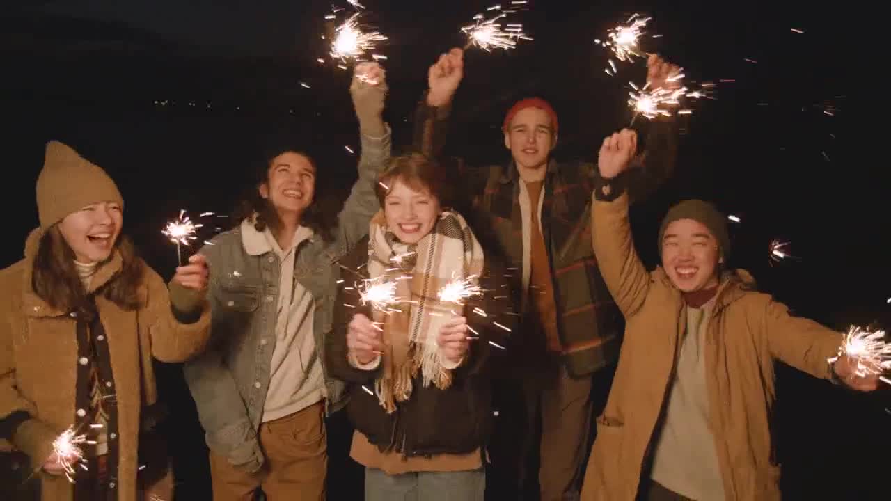 Friends celebrate new year night with sparklers preview