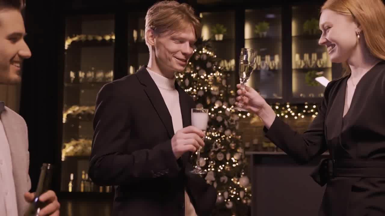 Man pouring champagne in glass on new year party preview