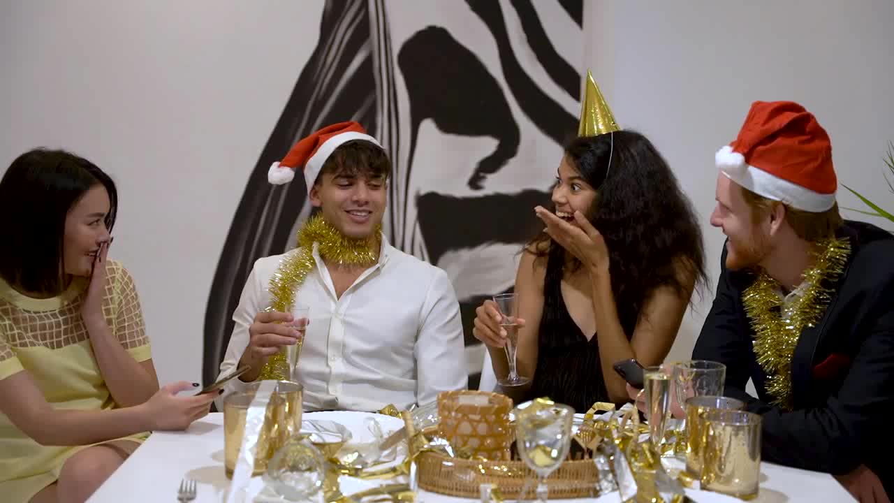 Friends sitting on table and enjoy christmas party preview