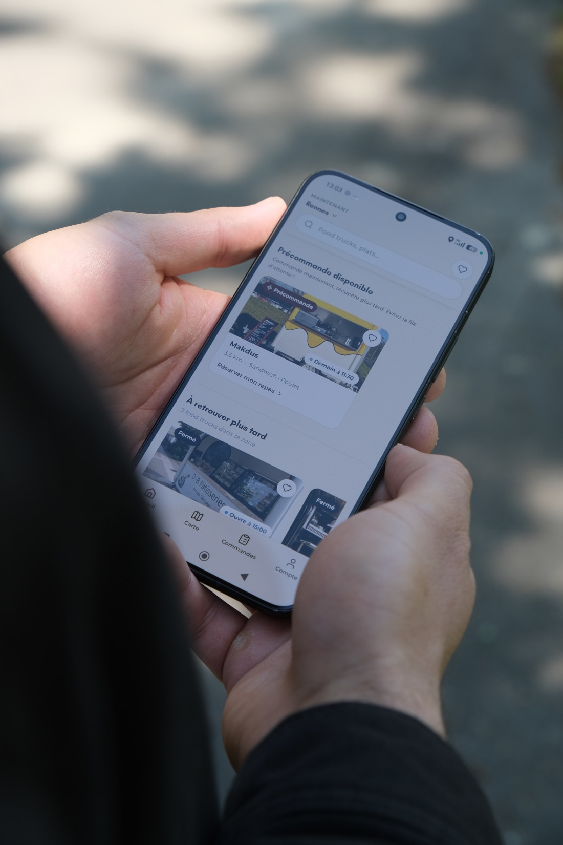 Smartphone affichant l'application Truckons avec « Précommande disponible » sur Makdus, food truck à 3,5 km, sandwich poulet, et bouton « Réserver mon repas »