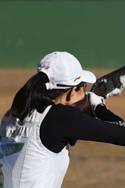 Instructor coaching a student on pistol grip