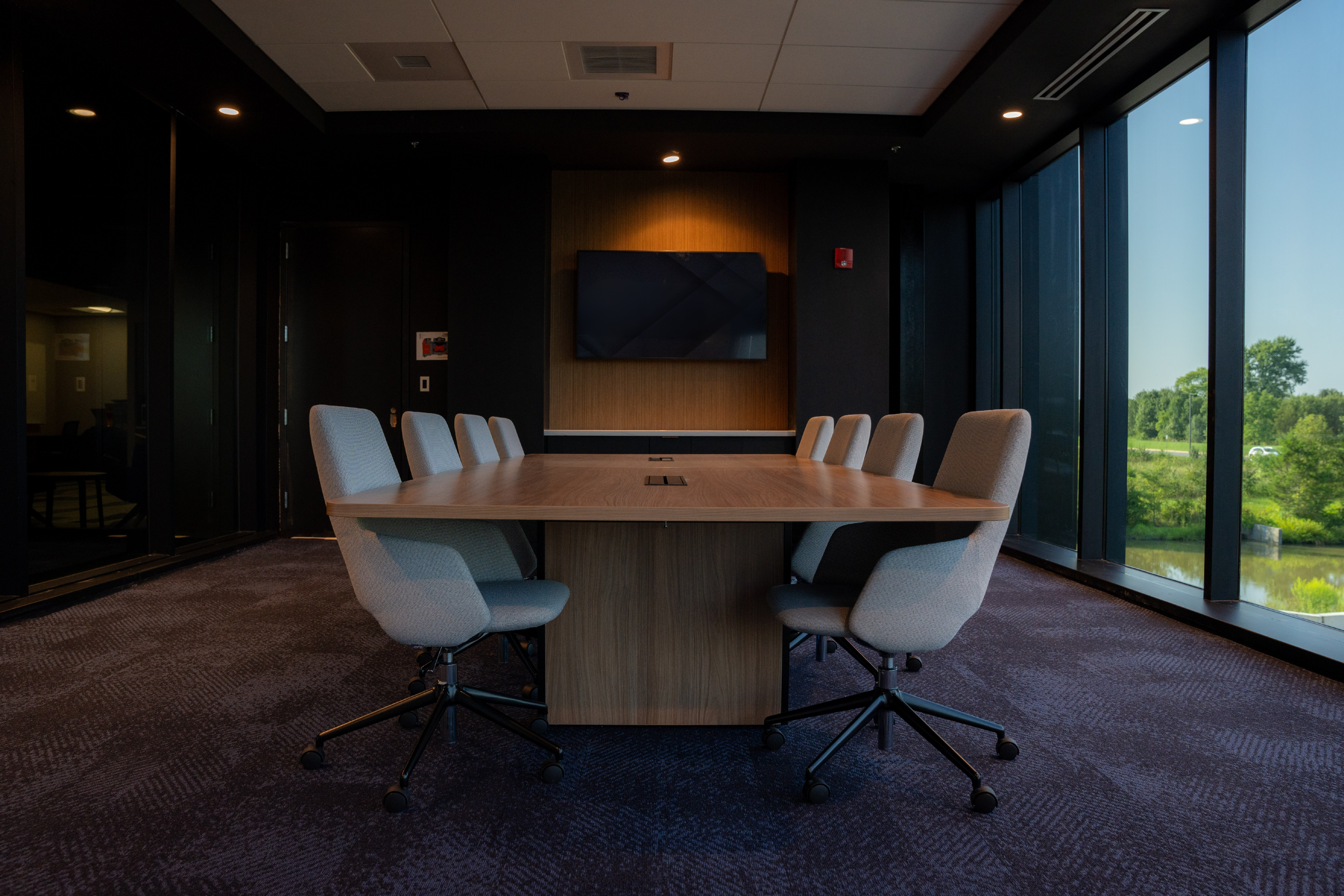 Dark themed office conference room photography at The Virginia Academy in Ashburn VA — commercial interior photographer