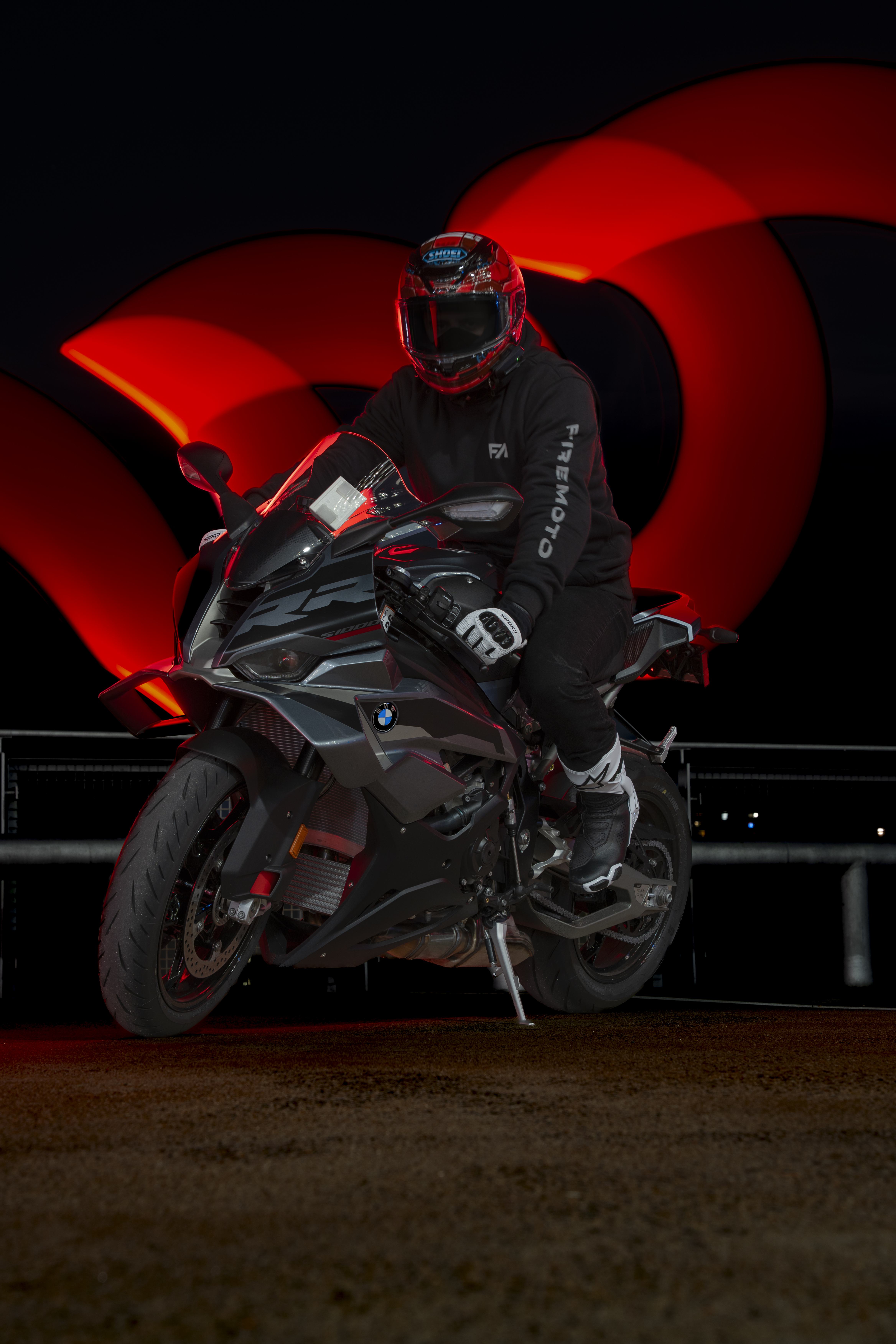 Speed biker on a BMW motorcycle with red long exposure light trails — automotive and motorcycle photography