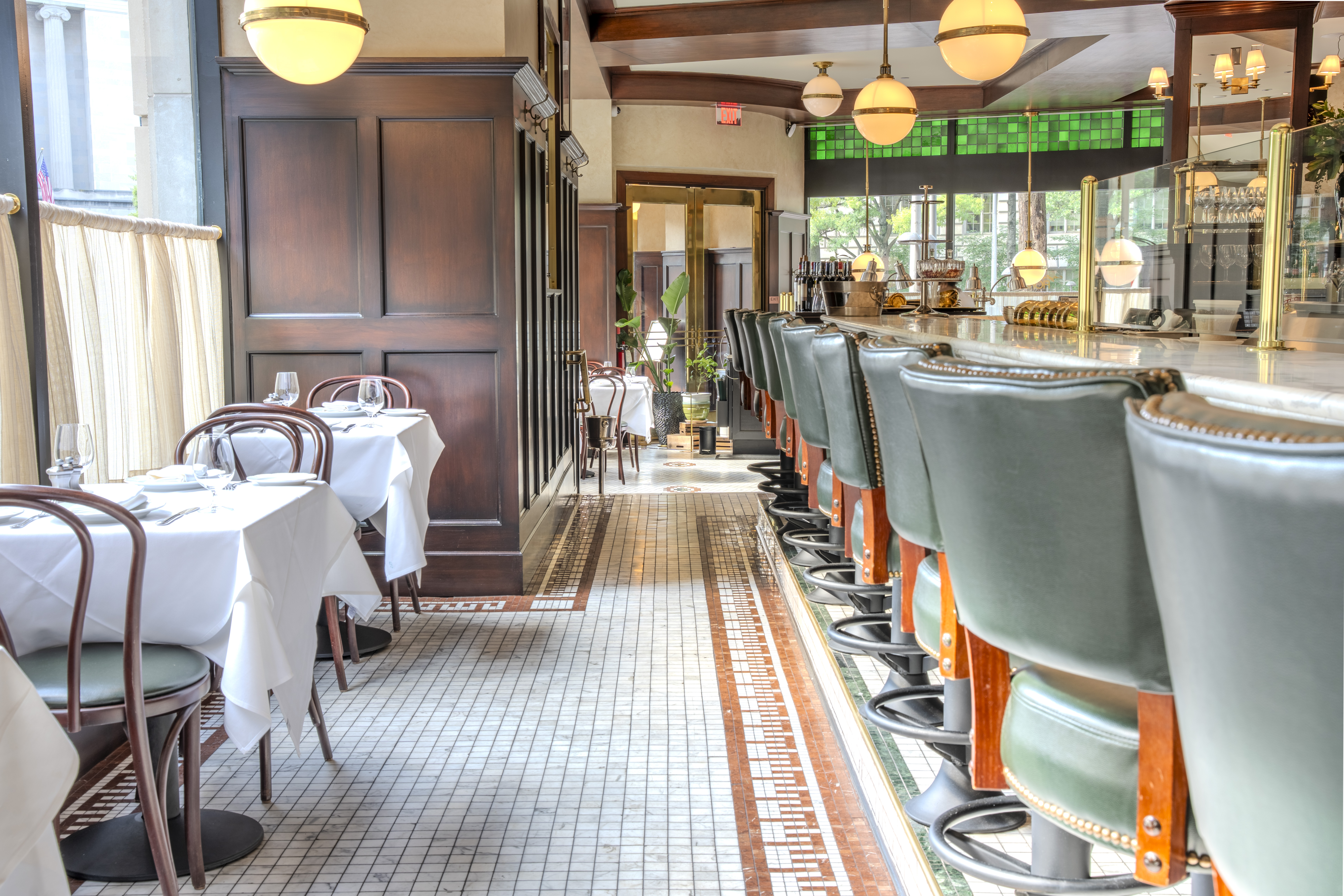 Dining area with green chairs at Cafe Fiorello, a new Italian restaurant in DC by Firemans Hospitality Group — restaurant photography