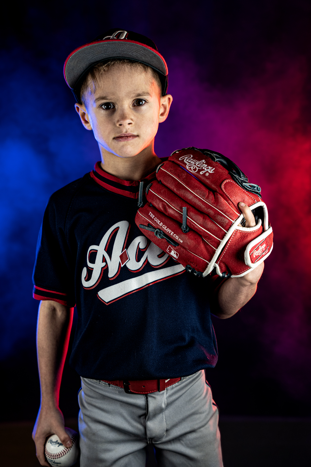 Loudoun Aces baseball player with red and blue lights and smoke in Loudoun County — athlete portrait photography with custom lighting