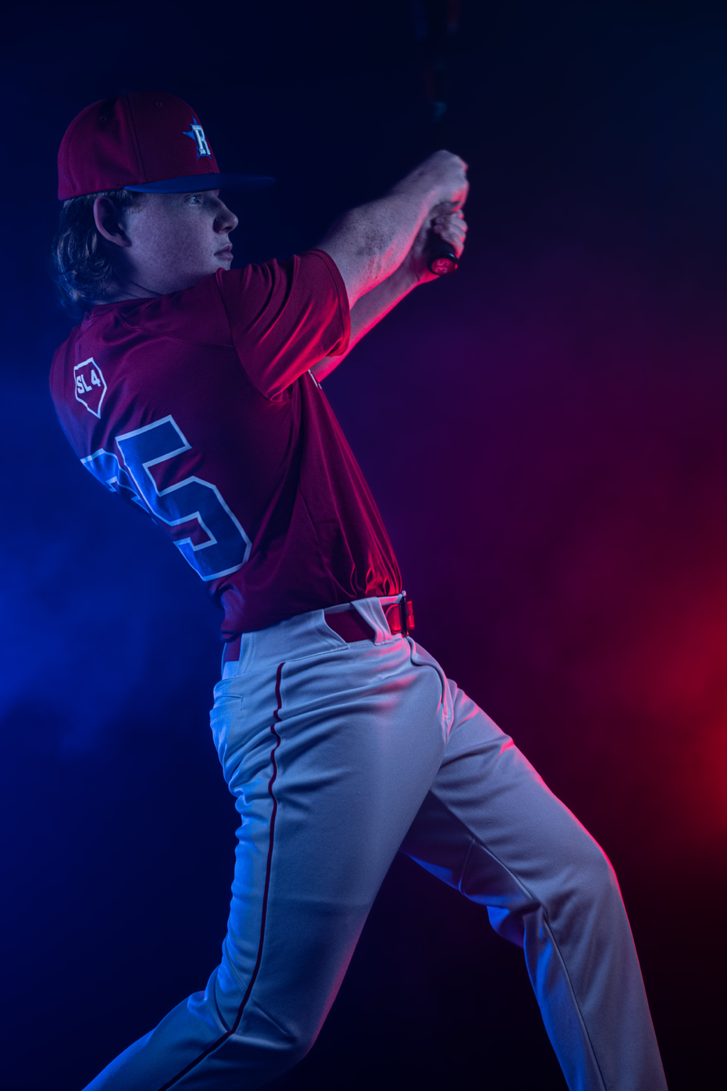 Replay Sports baseball player action shot with smoke and red and blue professional lighting in Ashburn VA — sports photography