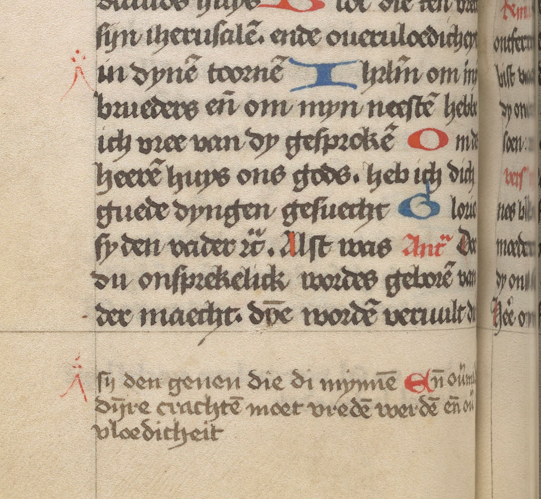 Detail of a manuscript’s lower text block and margin. A small red insertion mark sits to the left of the main text. A matching red mark below the ruled frame introduces a passage written in a smaller hand.