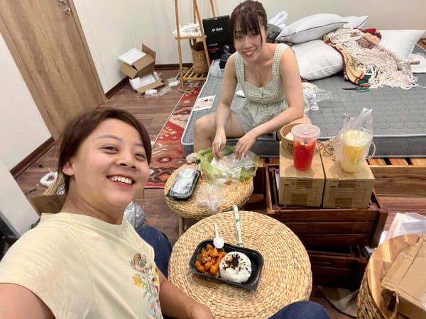Linh and Ngoc sharing a meal while working on the place
