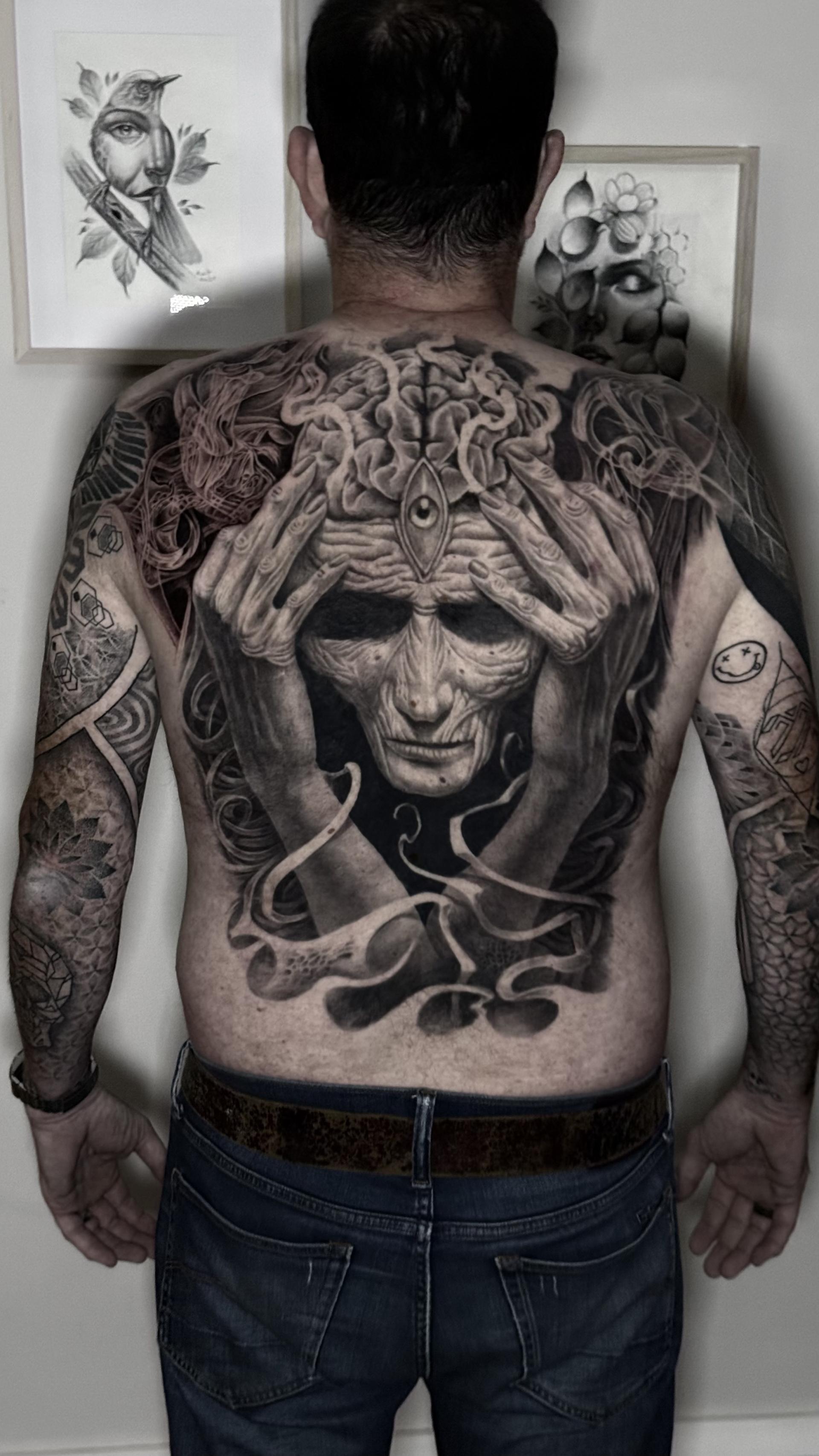Full back piece mythological face with snakes