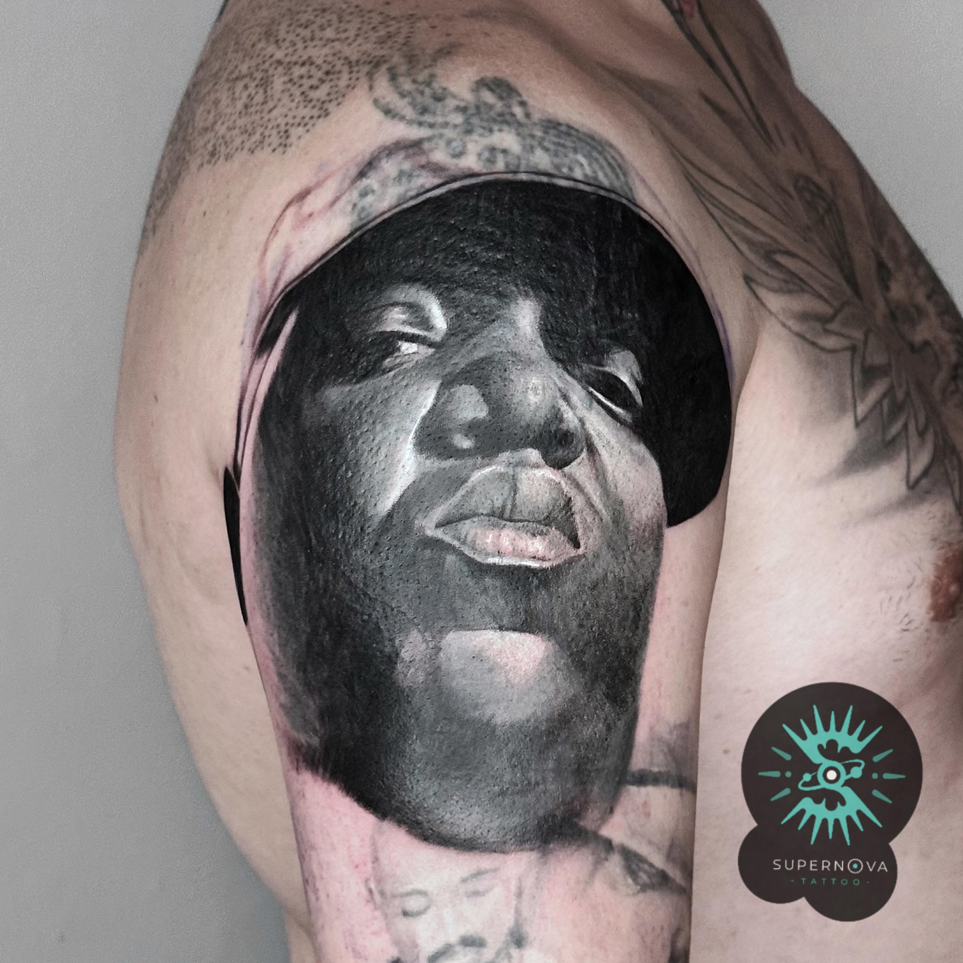 Biggie portrait realism on upper arm