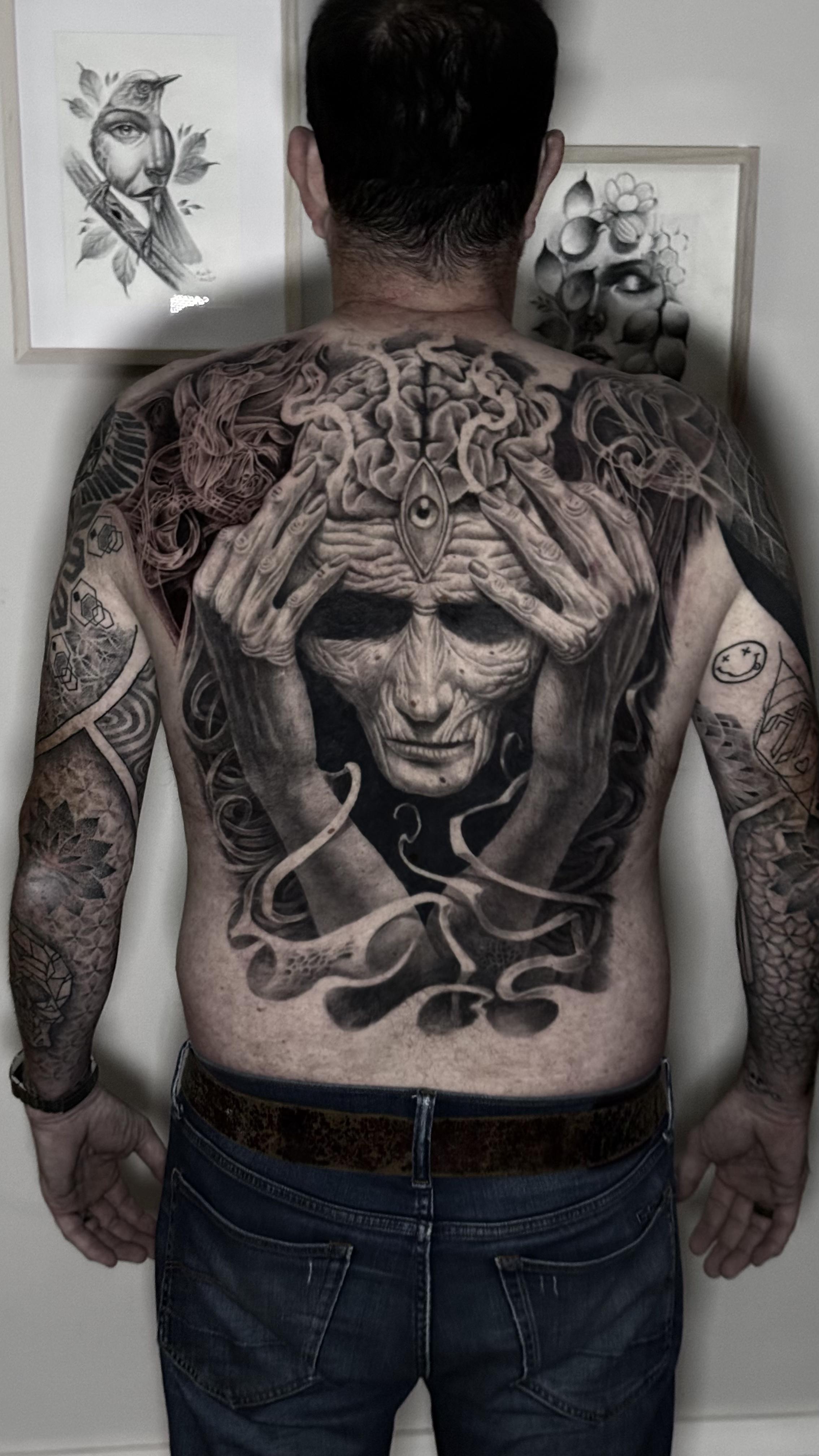 Full back piece mythological face with snakes