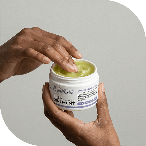 Hand applying Dr. Thrower's Beta Ointment from a jar