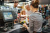 Lady cashier serving a family of three