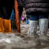 People walking through a flood