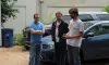 Three Zello employees standing in a car park